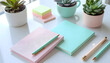 © Kixiiie - Minimalist Pastel Desk Setup with Notebooks, Pens, and Succulent Plants