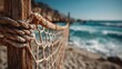 © Oulaphone - A close-up view of a rope net on a beach, with ocean waves in the background and a clear blue sky, creating a serene coastal atmosphere.