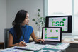 © crizzystudio - Businesswoman analyzing esg environmental social and corporate governance data on computer