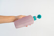 © apinya - Big purple shampoo bottle in hand on white background