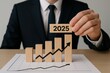 © Franklin - Businessman Presenting 2025 Growth Forecast with Wooden Blocks