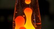 © Rajon Stocks - Close up of a retro lava lamp with orange wax floating in clear liquid