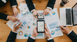 © Dual Studio - Business people using mobile phones and laptops, calculating and discussing charts and diagrams for financial report