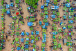 © AmazingAerialAgency - Kansat, Bangladesh - 15 June 2019: Aerial view of vibrant market scene, where farmers display their produce in lush green stacks, creating a captivating mosaic of agriculture.