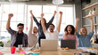 © Oksana_Latysheva - Startup team celebrating success in a bright office space. Joyful and diverse group of coworkers raising hands in teamwork celebration.