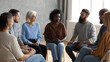 © Oksana_Latysheva - Support group of diverse individuals in a therapy circle discussing mental health. Inclusive and safe setting for emotional wellness themes.