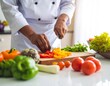 © tari - Chef chopping colorful vegetables on a wooden board