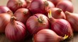 © Suwantono - A beautiful still life of fresh, vibrant red onions, some beginning to sprout, symbolizing new growth and farm-to-table cooking