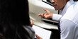© itchaznong - Insurance Consultation. Professional discussing vehicle damage details.