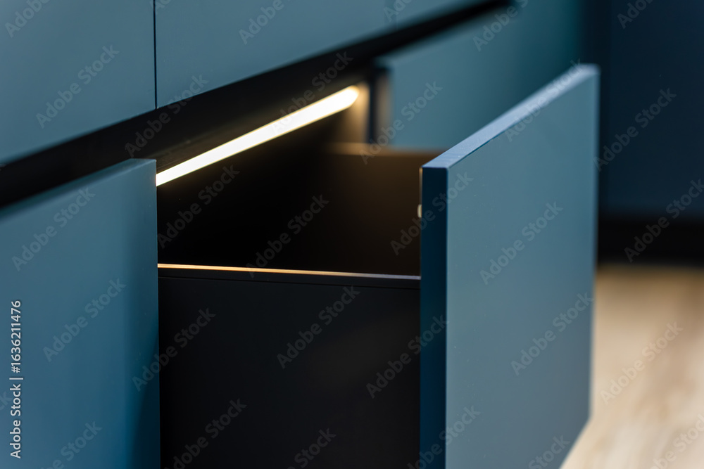 Led Between Drawers Pull out drawer. LED lighting. Blue fronts Stock Photo | Adobe Stock