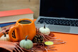 © Ksenia Belyaeva - Hot cup of coffee on desktop near laptop and books, online learning and freelancing
