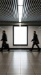 © Khasani - Two men in motion blur walk past a blank vertical billboard in a modern subway station.