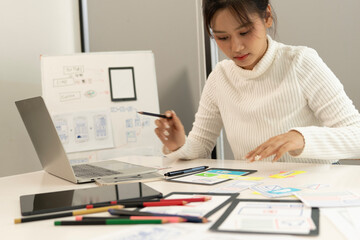 Wall Mural - Creative web designer planning UI application and developing digital template