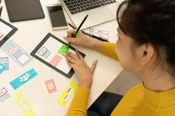 Wall Mural - Creative web designer planning UI application and developing digital template