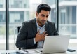 © MAJIDULISLAM - Business Man Experiencing Chest Pain While Working at Computer Stress and Health Concerns in the Workplace Requiring Medical Attention