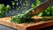 © Jane - A close-up of a knife chopping fresh herbs on a wooden cutting board