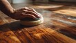 © Mitchell - Skilled hand buffs rich hardwood floor to a brilliant shine, restoring its natural beauty with care and precision.