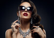 © KAMAPAN - fashion portrait of Beautiful sexy woman in jewelry and sunglasses. sexual girl over black background