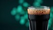 © BOJOShop - Close up of a dark beverage with a frothy head in a clear glass drink refreshment