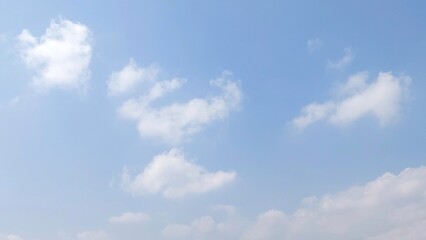 Wall Mural - Bright sky with white fluffy clouds in summer. Blue sky with clouds. Soft white clouds float in the clear blue sky. Clear blue sky, bright spring, wallpaper landscape.