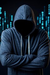 A man in a hoodie standing with his arms crossed in front of binary code