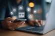 © Nusaibah - Person using smartphone and laptop, surrounded by digital marketing icons