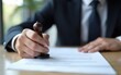 © liu - Businessman stamping contract document on desk, symbolizing legal approval, corporate agreement, and business authorization process. High quality