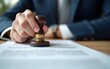 © nian - Man stamping approval on financial, banking, or investment documents at his desk official paperwork. rubber stamp with contract law and business documentation for legal agreements financial.