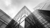 Modern Architecture: Low Angle View of a Glass Skyscraper Facade Against a Cloudy Sky, Monochrome