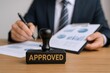 © Generative AI - Approved Stamp on Business Report with Executive Holding Pen, Emphasizing Authorization and Compliance