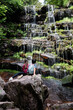 © Zoran Jesic - Young hikers admiring cascading waterfall in lush forest