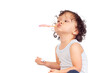 © Anetta - Cute curly haired toddler brushing his teeth with toothbrush and toothpaste