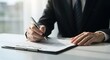 © ekam - Close-up of a businessman signing a document with a pen
