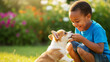 © Milan - Smiling african american boy feeding a corgi puppy in a garden. Happy black child playing with his cute dog outdoors.