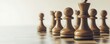 © kirania - Wooden chess pieces arranged on a chessboard.