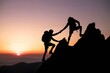 © salman - Two hikers assisting each other to reach mountain summit during stunning sunset
