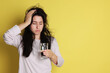 © New Africa - Woman with glass of water suffering from hangover on yellow background, space for text