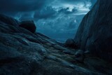 Dark, moonlit rocky landscape under stormy clouds