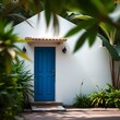 © Juli - tropical white building with blue door