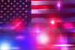 © New Africa - Police red and blue lights, double exposure with flag of United States of America