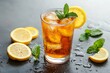 © Tamim - Refreshing iced tea with lemon slices and fresh mint garnish