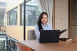 © jojo - Female employee working on laptop in office