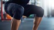 © NYPIXEL - Close-up of a person performing a squat in a gym, showcasing strength training and fitness equipment