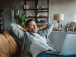 © SilverOwl - Relaxed freelancer leaning back on a couch with a laptop in front of him—perfect for illustrating remote work freedom, work-life balance, or home office comfort.