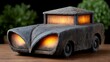 © BOJOShop - Stone car lantern with illuminated headlights and interior set against a dark background with greenery