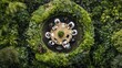 © Galih - Aerial view of a meeting at a round table surrounded by lush, green foliage