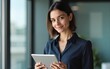 © ning - Female portrait latin ceo leader business woman in office, holding digital device, looking at camera. Middle age manager specialist businesswoman using tablet pc at work for financial data analyzing