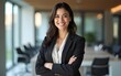 © feng - Vertical portrait of middle age manager adult executive CEO entrepreneur businesswoman. Leader smiling latin hispanic, middle eastern business woman standing arms crossed in office looking at camera.