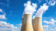 © siraphol - Cooling towers releasing steam against blue sky with clouds create striking industrial scene