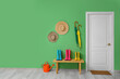 © Pixel-Shot - Interior of stylish hallway with gumboots on wooden bench and white door